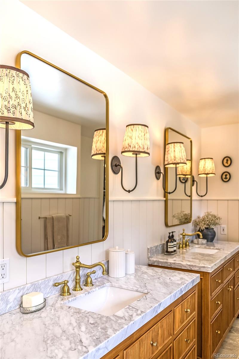 475 Silbrico Way Castle Rock, CO 80108 - Photo 35 of 50 a bathroom with a granite countertop sink and a mirror
