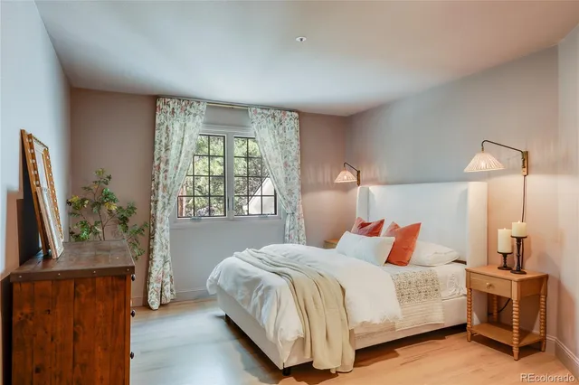 a bed sitting in a bedroom next to a window