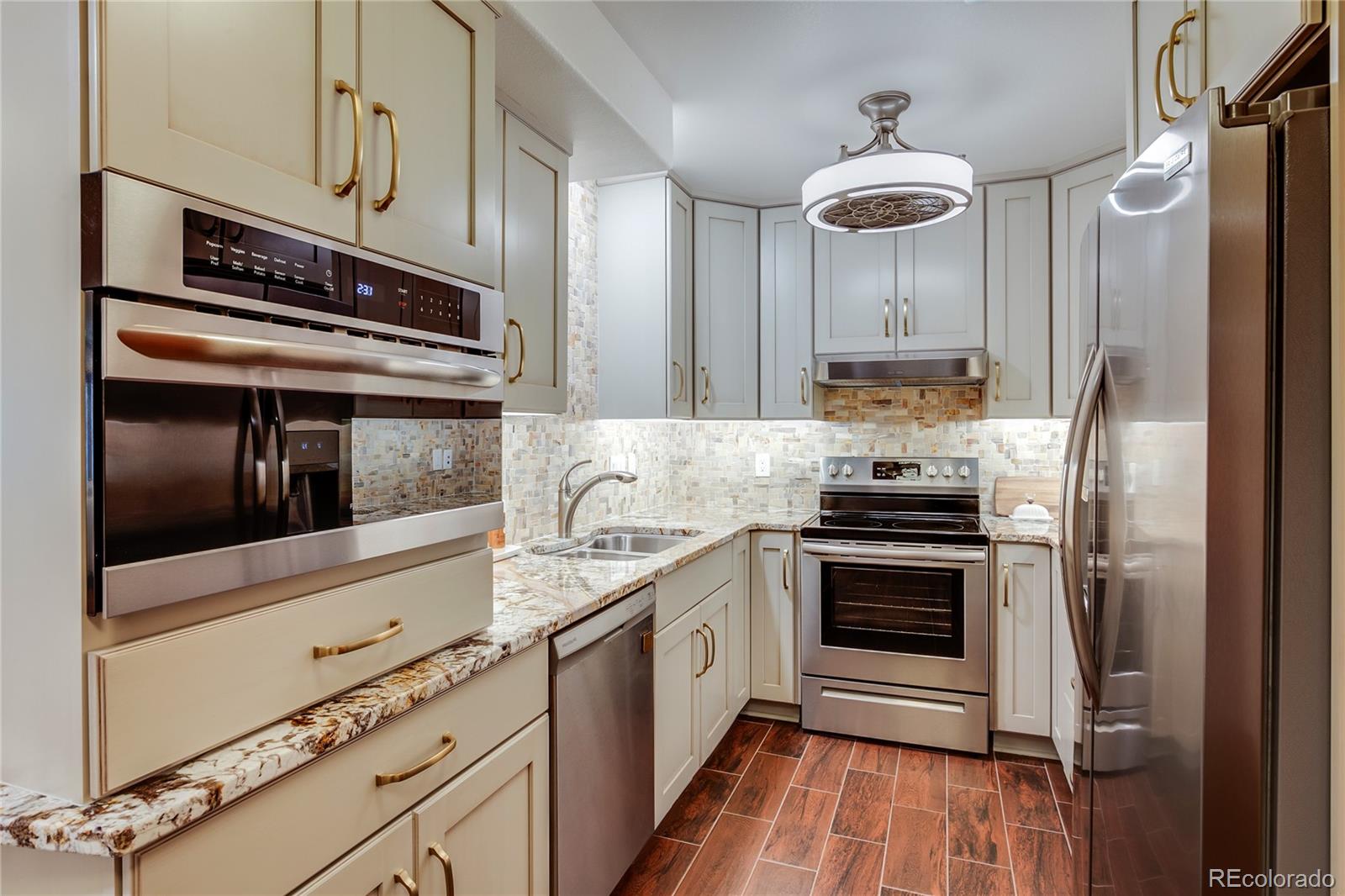 475 Silbrico Way Castle Rock, CO 80108 - Photo 41 of 50 a kitchen with stainless steel appliances a stove microwave and refrigerator