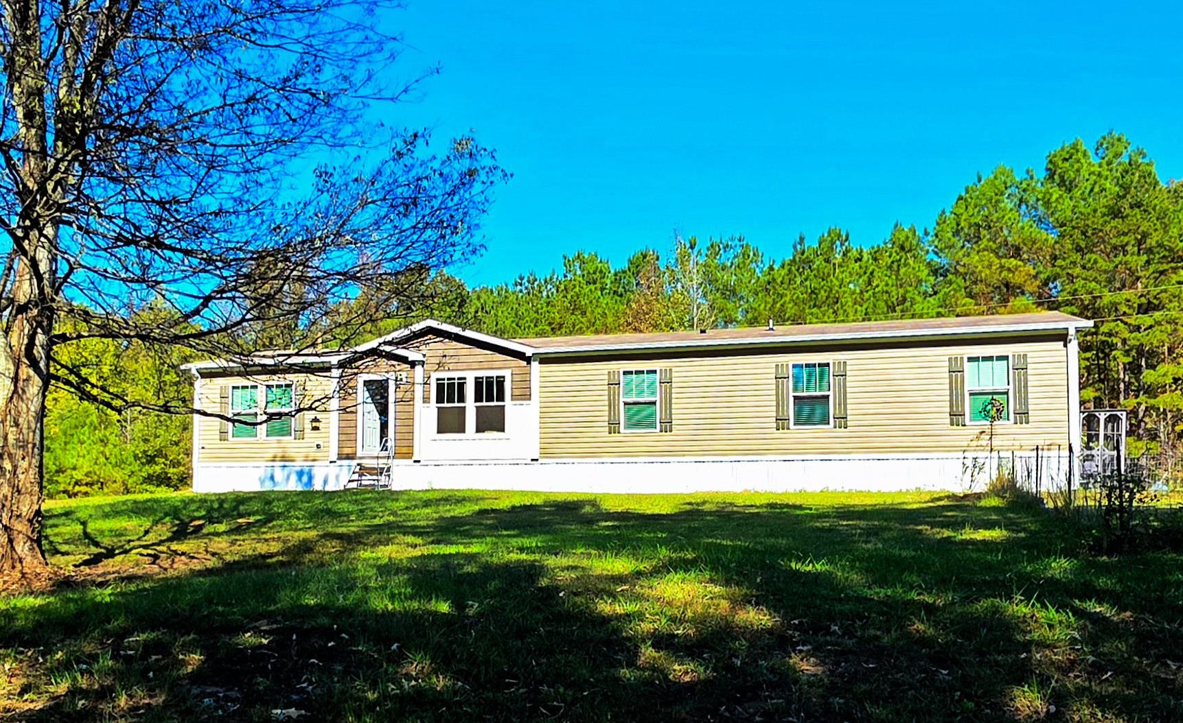 a front view of house with yard and green space