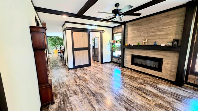 a view of an empty room with a fireplace and a window