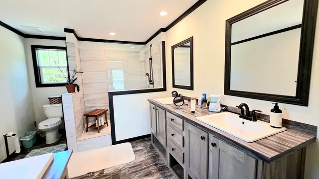 a bathroom with a double vanity sink mirror and