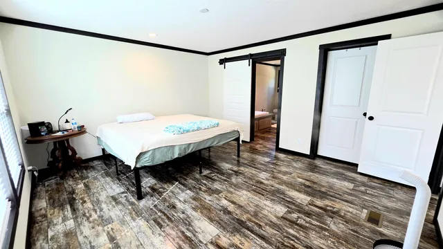 a front view of house with yard and trees in the background