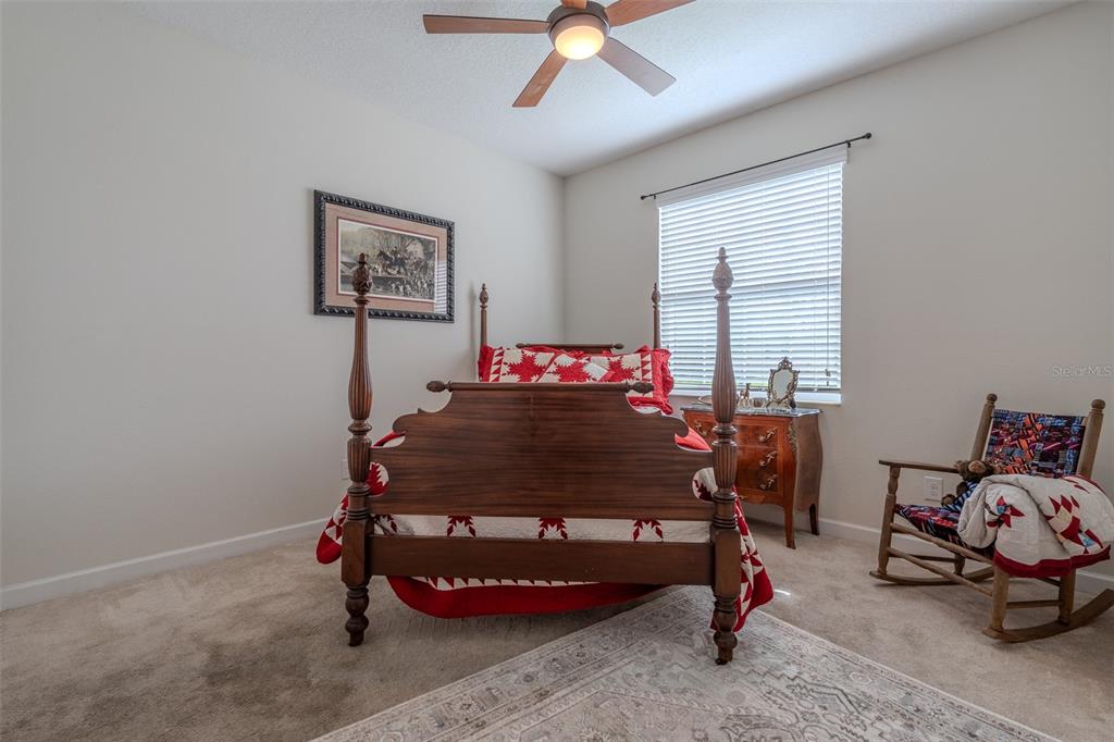 9224 Southwest 60th Ct Road Ocala, FL 34476 - Photo 40 of 55 a bedroom with a bed and a chandelier