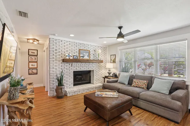 a view of a dining room with furniture wooden floor and a chandelier