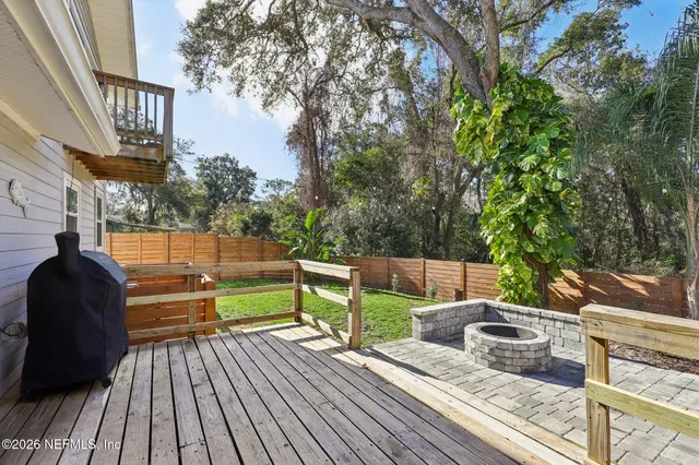 a view of a street sign under a large tree