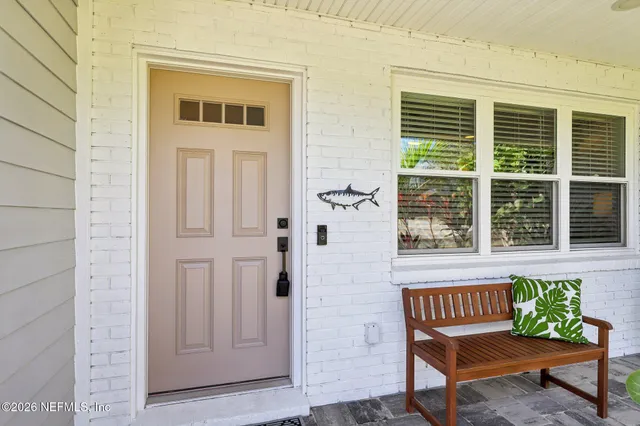 a living room with furniture a fireplace and a large window