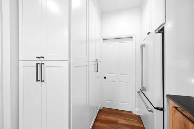 a bathroom with a sink vanity mirror and toilet