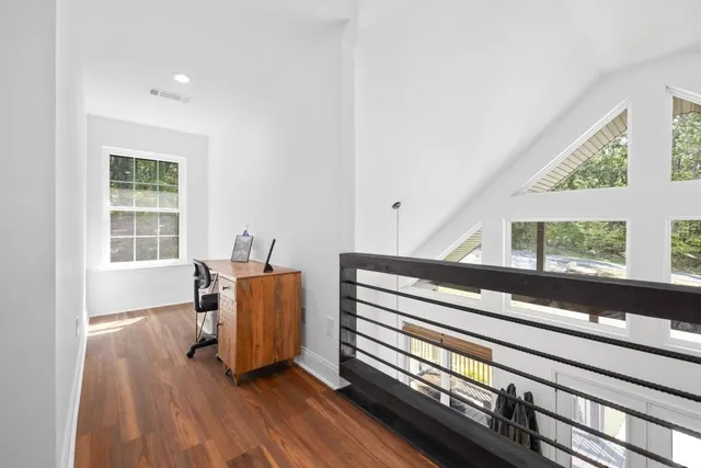 a bedroom with a bed and a flat tv screen on dresser