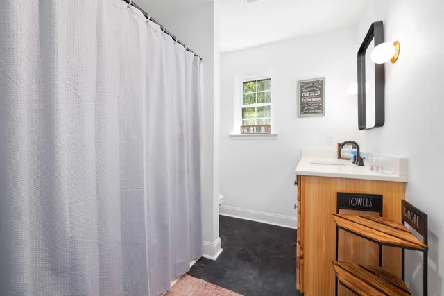a view of bedroom with natural light and wooden floor