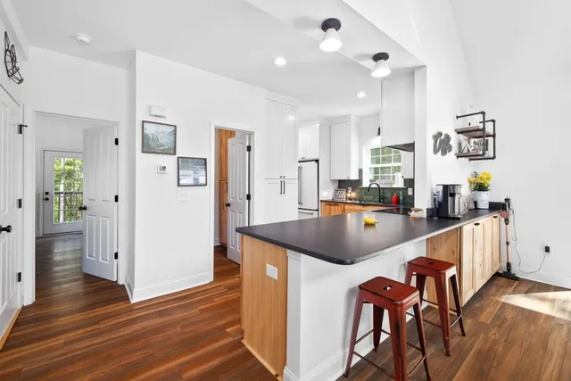 a kitchen with stainless steel appliances granite countertop a sink and a refrigerator