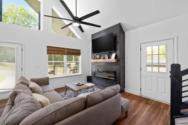 a living room with furniture a window and a ceiling fan