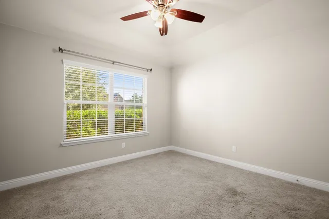 a bathroom with a granite countertop sink a toilet and a mirror