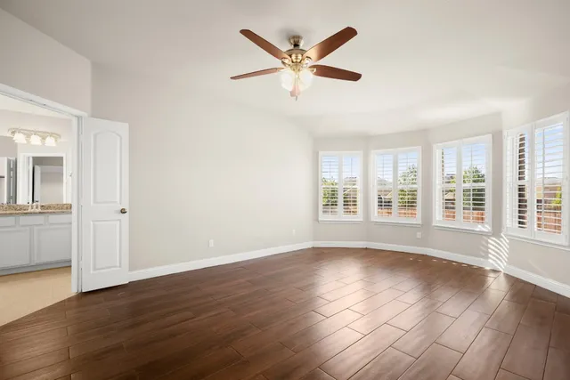 a view of wooden floor and a window in a room