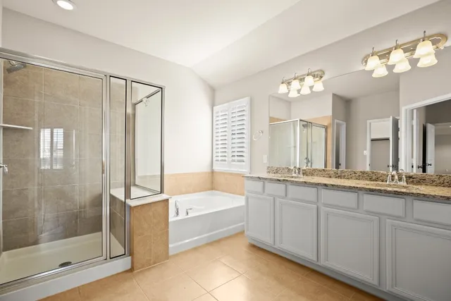 a bathroom with a tub sink and mirror