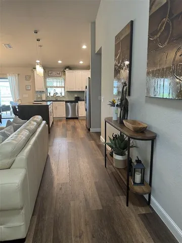 a kitchen with kitchen island a stove a sink and a refrigerator