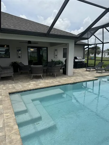 a dining room with furniture and a kitchen view