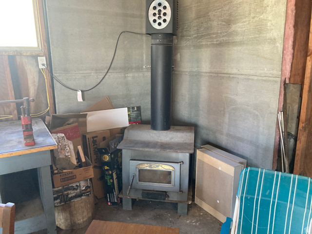 200 South 2800th Street West Ogden, UT 84404 - Photo 24 of 42 Detailed view of unfinished concrete floors and a wood stove
