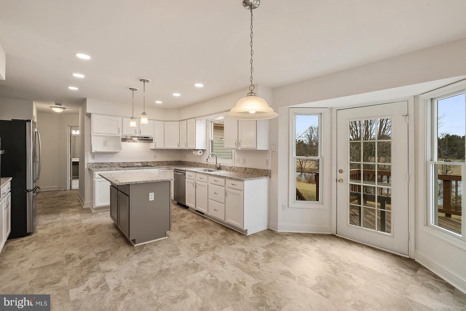Kitchen has new appliances, lighting, flooring,