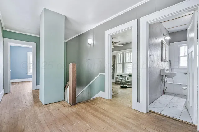 a view of entryway with bathroom and wooden floor