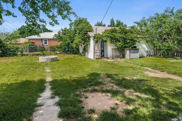 a front view of a house with yard and green space