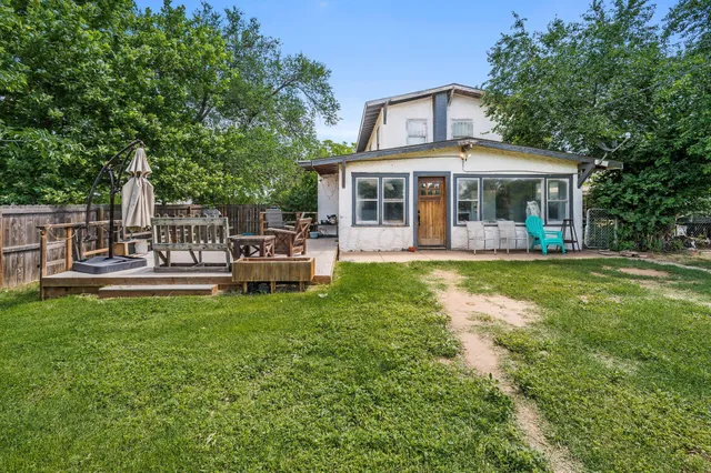 a front view of a house with garden and sitting area