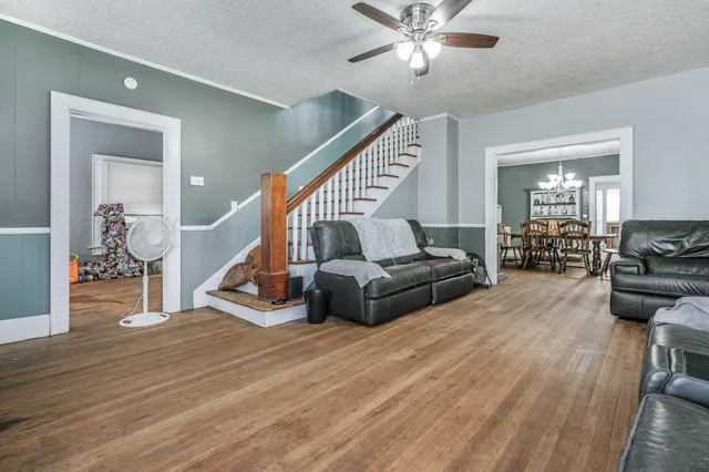 a living room with furniture and wooden floor