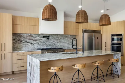 a large kitchen with stainless steel appliances granite countertop a stove and a sink
