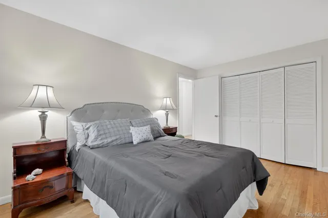 a bedroom with a bed and a lamp