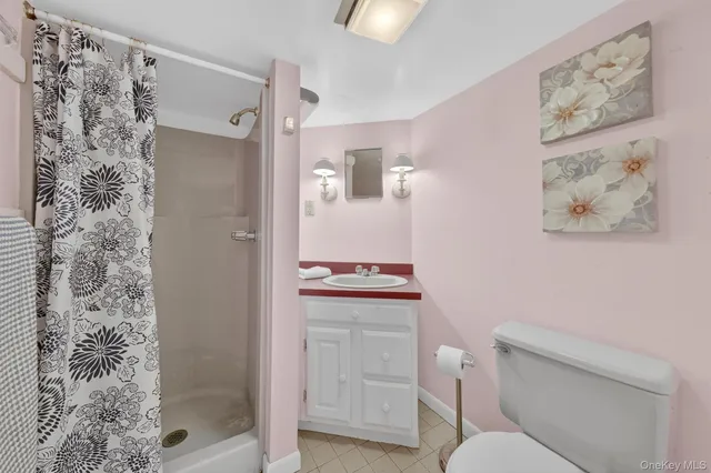 a bathroom with a toilet sink and shower