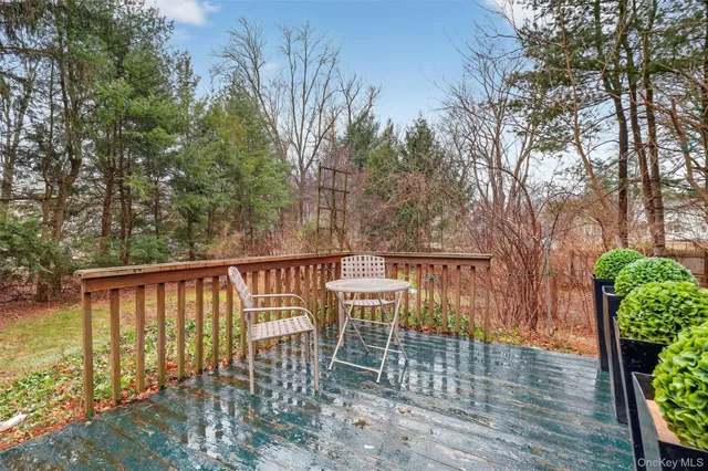 a view of a balcony with wooden floor and fence