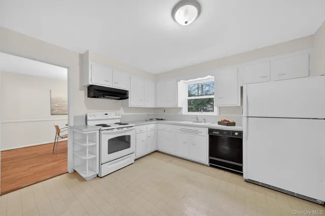 a kitchen with stainless steel appliances a refrigerator sink and stove
