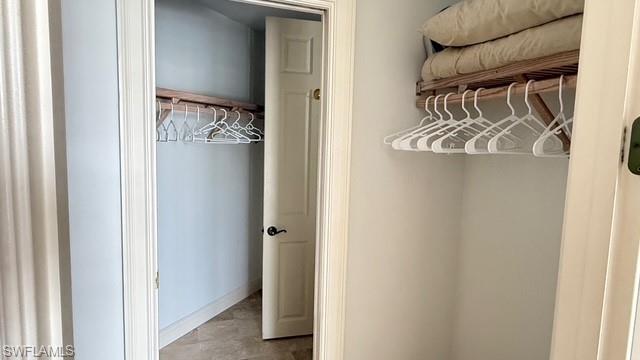391 4th Street South, Unit 401 Naples, FL 34102 - Photo 16 of 31 a view of walk in closet with clothes