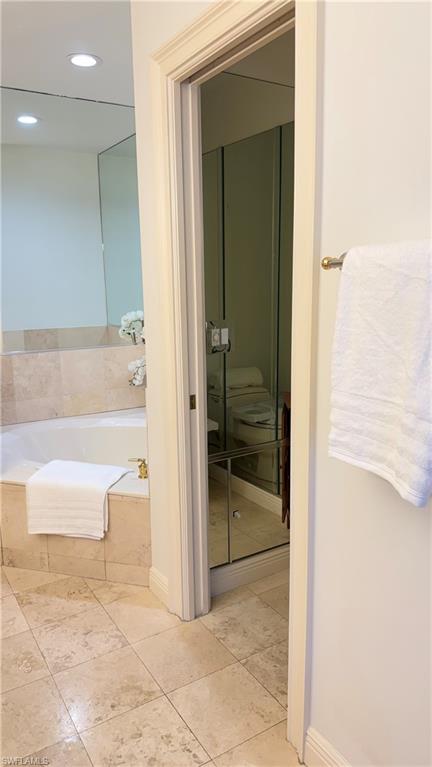391 4th Street South, Unit 401 Naples, FL 34102 - Photo 19 of 31 a bathroom with a tub shower and sink