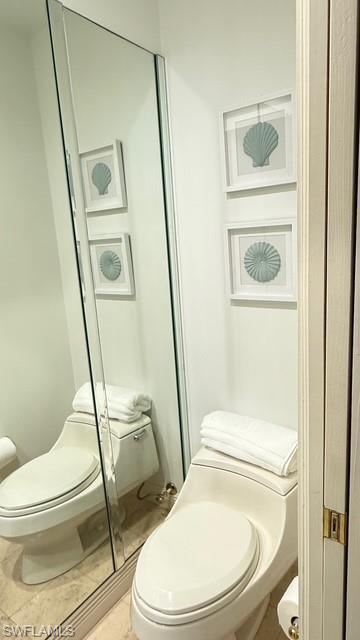 391 4th Street South, Unit 401 Naples, FL 34102 - Photo 20 of 31 a white toilet sitting next to a bathroom sink