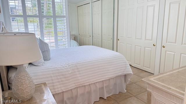 391 4th Street South, Unit 401 Naples, FL 34102 - Photo 24 of 31 a large bed sitting in a bedroom next to a window