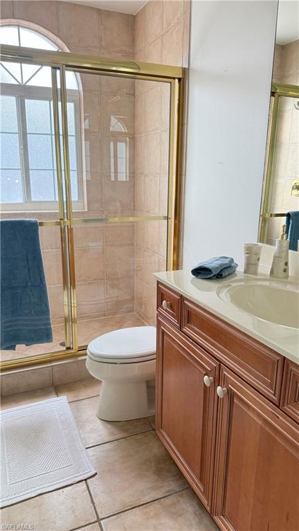 391 4th Street South, Unit 401 Naples, FL 34102 - Photo 26 of 31 a bathroom with a sink a toilet and shower