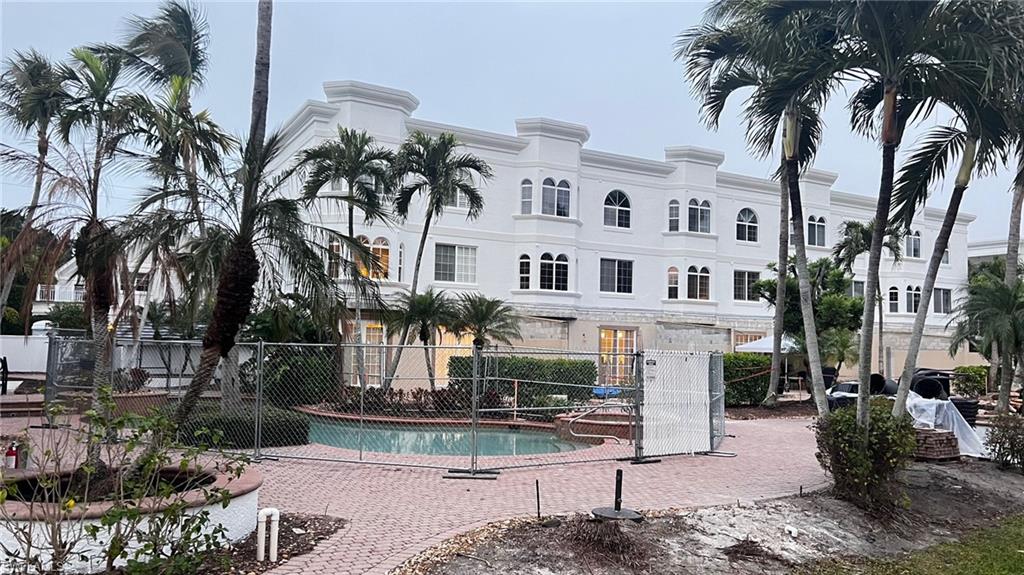 391 4th Street South, Unit 401 Naples, FL 34102 - Photo 31 of 31 a front view of a building with palm trees