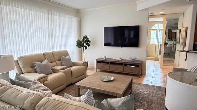 391 4th Street South, Unit 401 Naples, FL 34102 - Photo 4 of 31 a living room with furniture and a flat screen tv