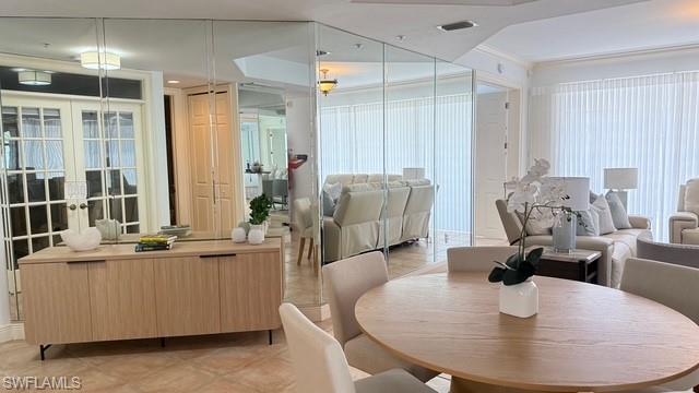 391 4th Street South, Unit 401 Naples, FL 34102 - Photo 5 of 31 a dining room with couches a table and chairs
