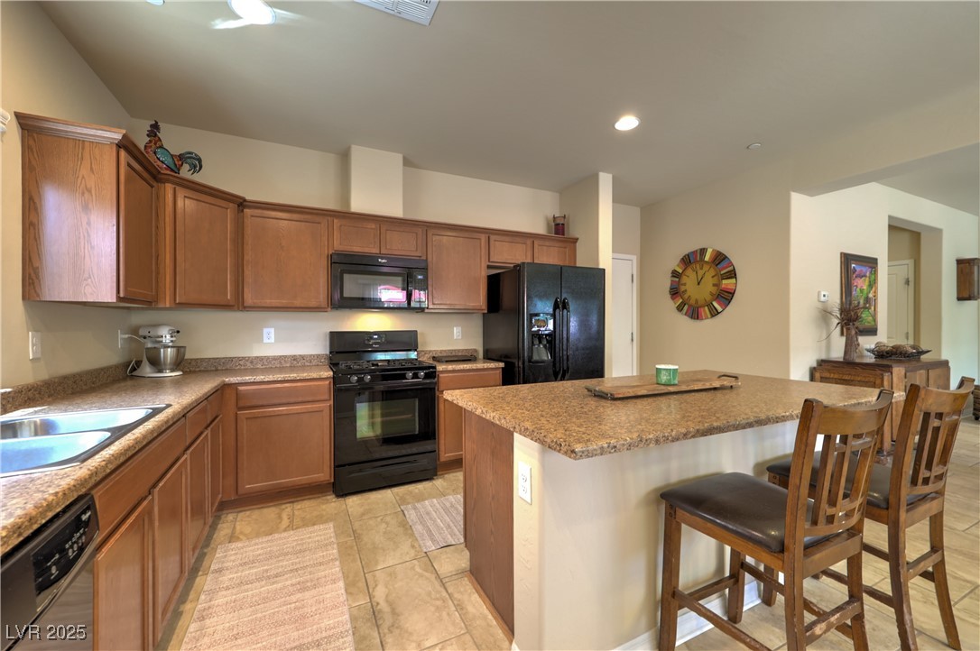 2373 Rue Royale Street Henderson, NV 89044 - Photo 12 of 29 Kitchen featuring black appliances, a sink, a brea