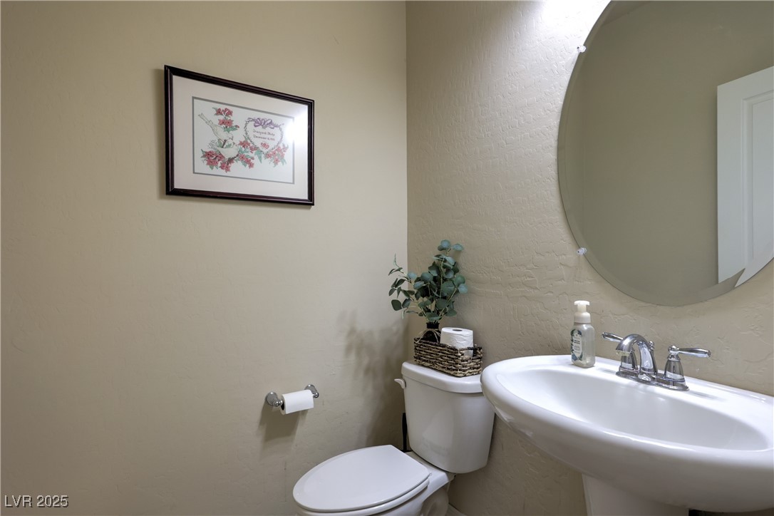 2373 Rue Royale Street Henderson, NV 89044 - Photo 15 of 29 Downstairs featuring a sink, toilet, and a texture