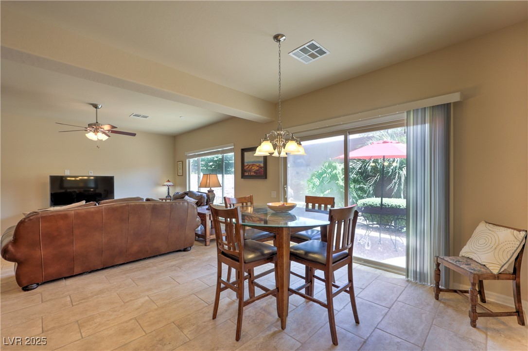 2373 Rue Royale Street Henderson, NV 89044 - Photo 9 of 29 Dining room featuring a chandelier and ceiling fan