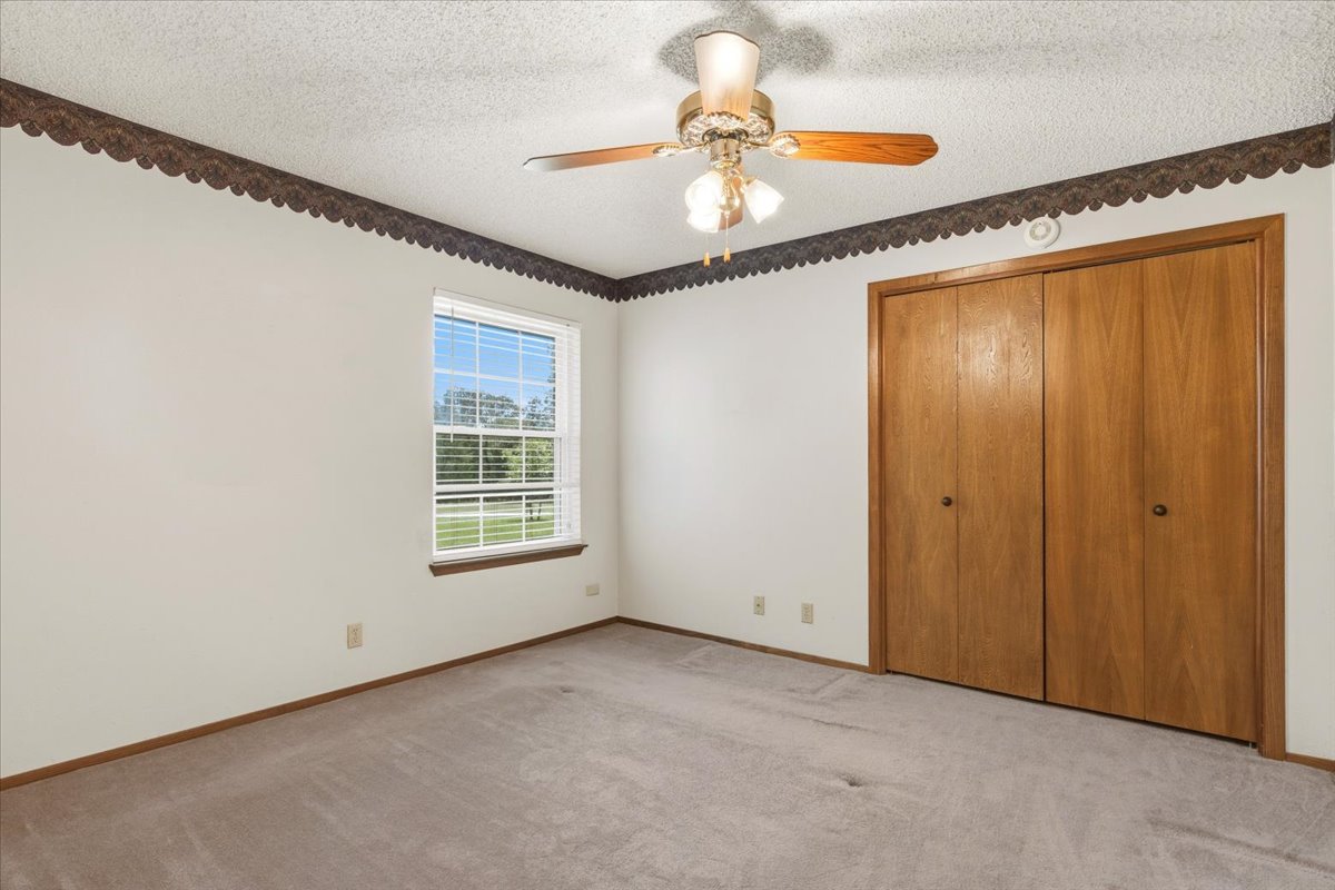 250 Hickory Drive Elgin, TX 78621 - Photo 19 of 37 a view of an empty room with window chandelier fan