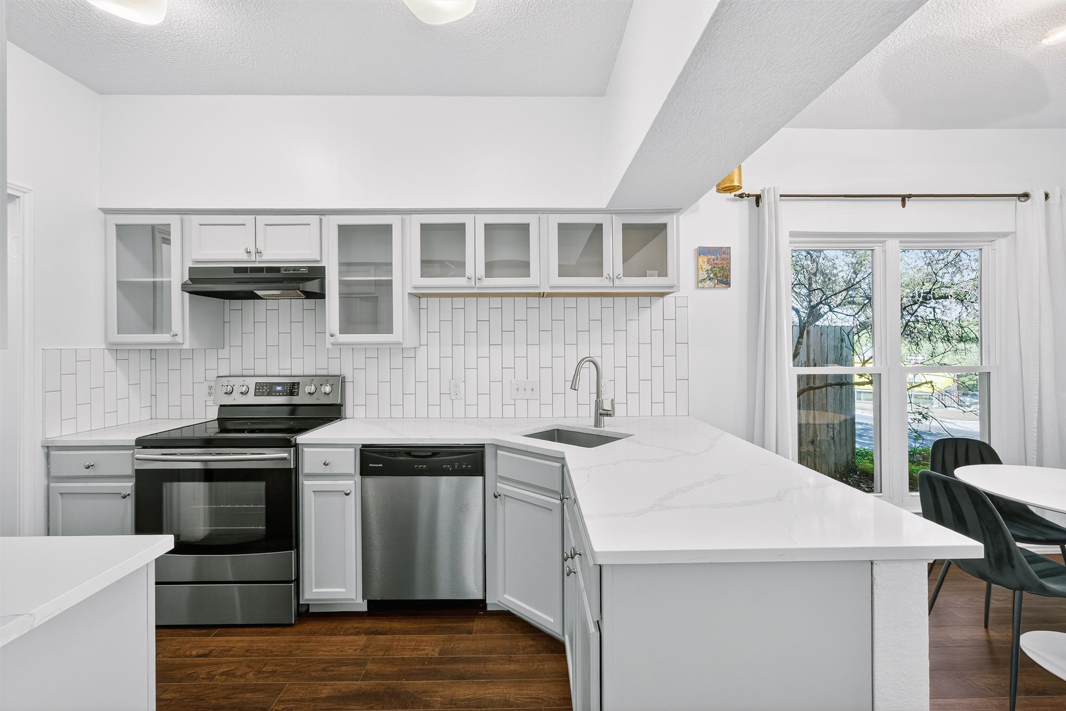3809 Spicewood Springs Road, Unit 103 Austin, TX 78759 - Photo 12 of 39 Stainless steel appliances and glass front cabinets
