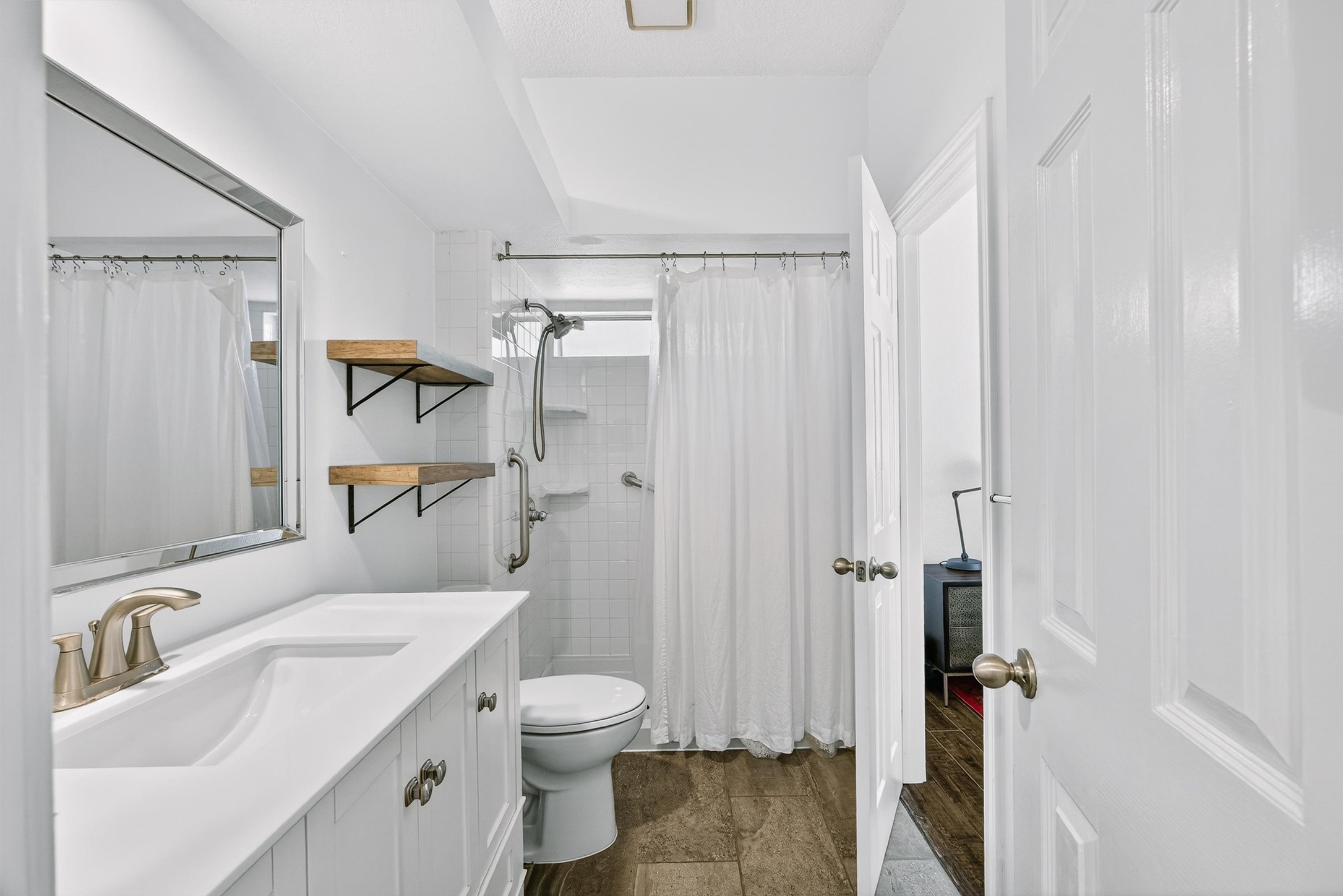 3809 Spicewood Springs Road, Unit 103 Austin, TX 78759 - Photo 20 of 39 Quartz countertops and walk-in shower with subway tile.
