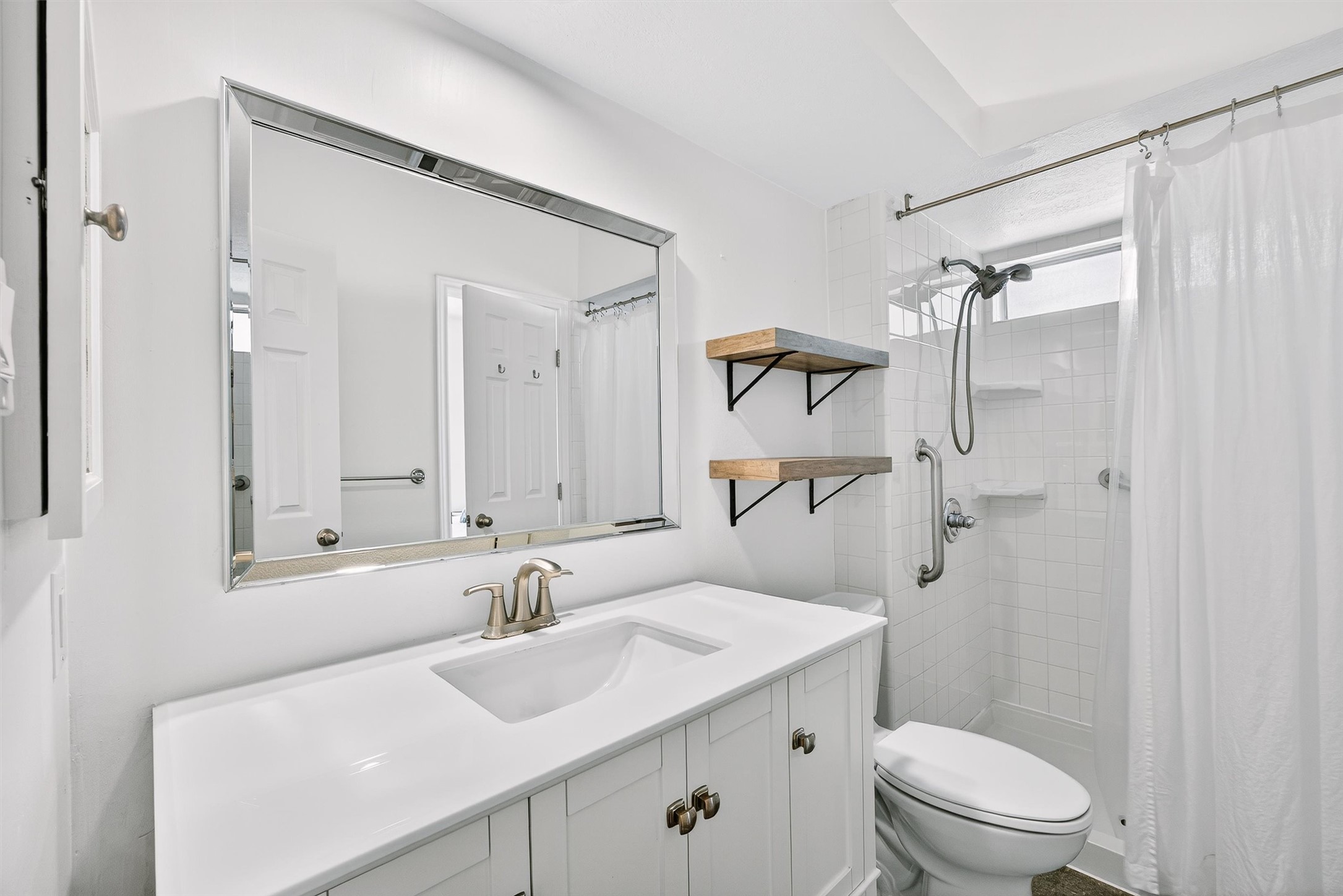 3809 Spicewood Springs Road, Unit 103 Austin, TX 78759 - Photo 21 of 39 Quartz countertops and walk-in shower with subway tile.