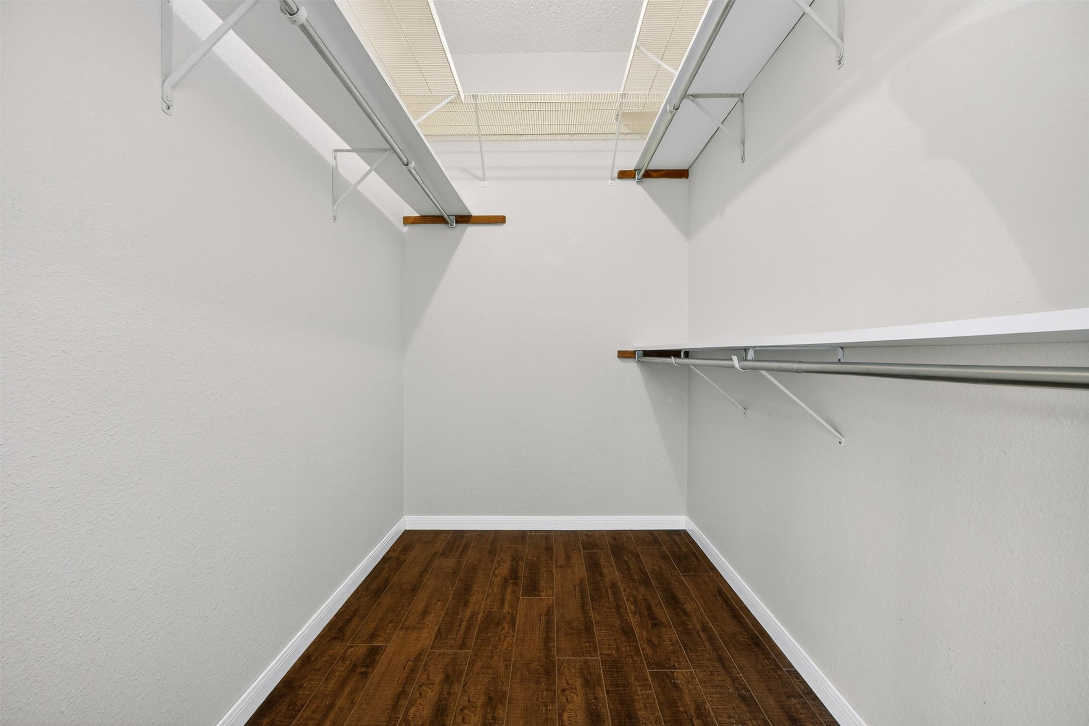 3809 Spicewood Springs Road, Unit 103 Austin, TX 78759 - Photo 25 of 39 Walk in closet with wood-like flooring