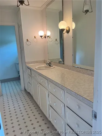 a bathroom with a sink a vanity and a mirror