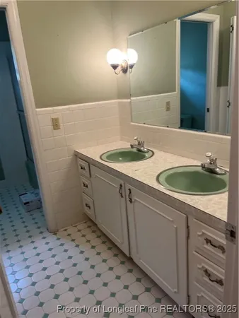 a bathroom with a sink a vanity and mirror